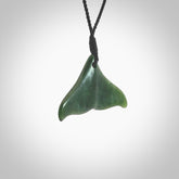 Hand carved small New Zealand Jade whale tail pendant. Carved for NZ Pacific. Handmade ocean themed jewellery for sale online. Hand made by Kyohei Noguchi.